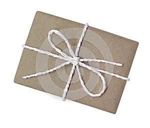Gift box wrapped in brown recycled paper and tied cotton rope to