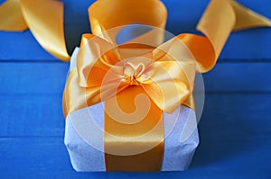 Gift box wrapped with craft paper and bow on neutral background with boke. Holiday concept.