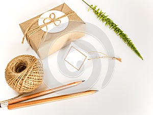 Gift box wrapped in kraft paper and rustic hemp as natural rustic style