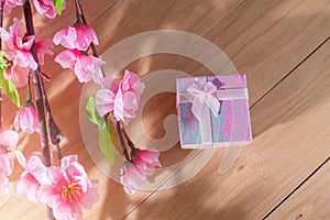 Gift box wrapped and plum blossom Christmas and Newyear presents with bows and ribbons, Christmas frame boxing day background.