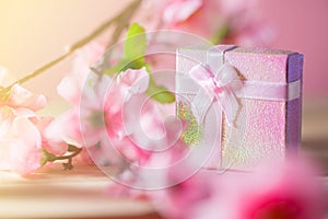 Gift box wrapped and plum blossom Christmas and Newyear presents with bows and ribbons, Christmas frame boxing day background.