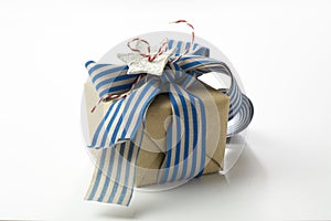 Gift box wrapped in recycled paper, blue ribbon bow