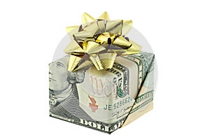 A gift box wrapped with US dollar decorated with golden gift ribbon