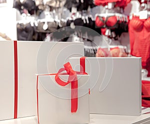 Gift boxes on the background of a lingerie store. Advertising, sales, fashion concept