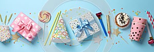 Gift boxes and birthday accessories on blue background