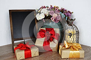 Gift boxes and Blackboard wooden easel with flower and LED candle light decoration