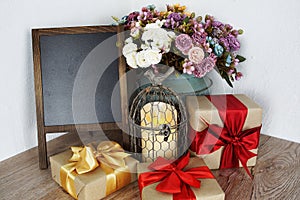 Gift boxes and Blank Blackboard wooden easel with flower and LED candle light decoration