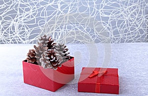 Gift boxes with bow and christmas balls on wood background. Decoration