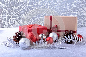 Gift boxes with bow and christmas balls on wood background. Decoration