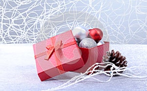 Gift boxes with bow and christmas balls on wood background. Decoration