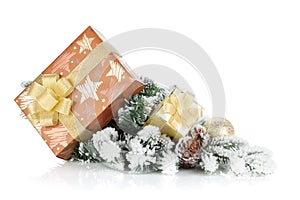 Gift boxes and christmas decor on snowy fir tree