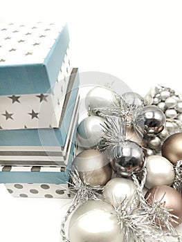 Gift boxes and Christmas decorations with silvered ribbons in white background