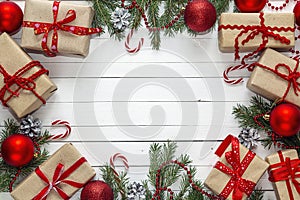 Gift boxes and Christmas decorations on white wooden background.