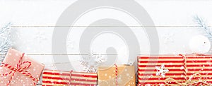 Gift boxes and Christmas ornaments on white wood background
