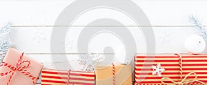 Gift boxes and Christmas ornaments on white wood background