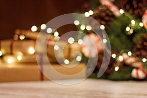 Gift boxes and Christmas wreath with a luminous garland. Blurred background without focus with bokeh