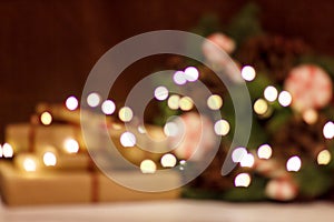 Gift boxes and Christmas wreath with a luminous garland. Blurred background without focus with bokeh