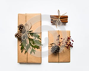 Gift boxes in craft paper on white background. Christmas or other holiday concept, top view, flat lay