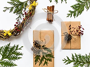 Gift boxes in craft paper on white background. Christmas or other holiday concept, top view, flat lay