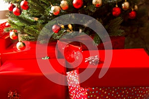 Gift boxes and decorated christmas tree, closeup