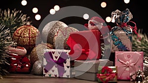 Gift boxes and decorations on table with lights in background