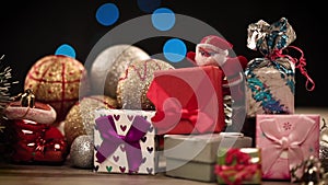 Gift boxes and decorations on table with lights in background