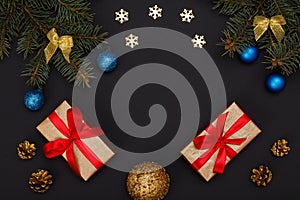 Gift boxes, fir tree branches with cones on black background