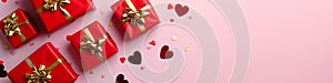 Gift boxes with golden ribbon bow and red hearts on light pink background. Present for Valentine's and Women's day