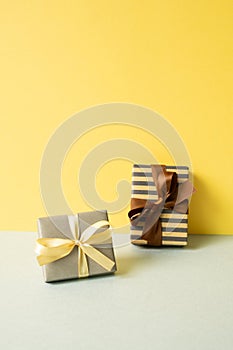 Gift boxes on gray table. yellow wall background