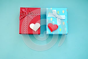 Gift boxes and hearts on a blue background