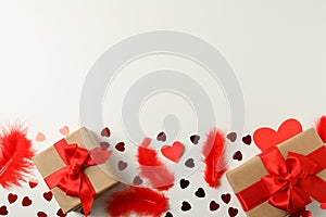 Gift boxes, hearts and feathers on white background