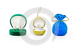 Gift boxes for jewelry with gold wedding rings and gold engagement ring with blue topaz.