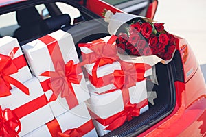 Gift boxes in a luggage carrier of the red car