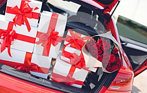 Gift boxes in a luggage carrier of the red car