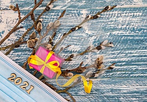 Gift boxes with origami ribbons. Willow twigs. Holy Easter. Blue turquoise background