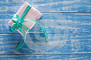 Gift boxes in paper on a blue wooden table