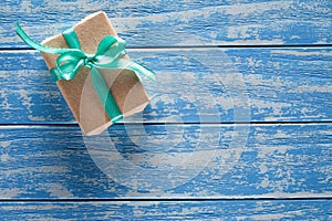 Gift boxes in paper on a blue wooden table