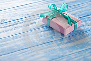 Gift boxes in paper on a blue wooden table