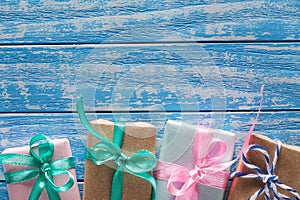 Gift boxes in paper on a blue wooden table