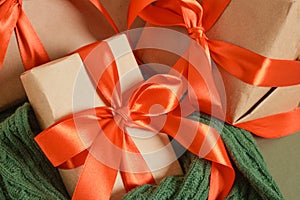 gift boxes with red ribbons on a green background, craft decorations and gifts