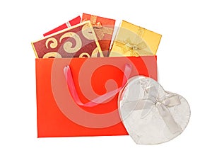 Gift boxes in red shopping bag isolated on white