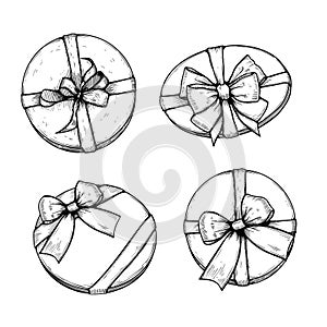 Gift boxes with ribbons and bows set. Hand drawn sketch illustrations collection. Top view close up drawing of round gift boxes