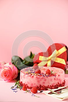 Gift boxes in shape of heart, roses, raspberry cake with fresh berries, rosemary and dry flowers on pink background. Banner, copy