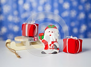 Gift boxes on sleigh and santa claus, on blue background