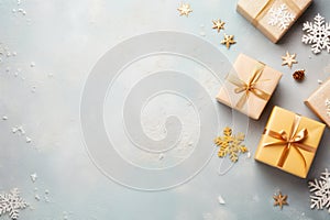Gift boxes, snowflakes and decorated Christmas fir tree branches on grey background flat lay frame, top view copy space, pastel