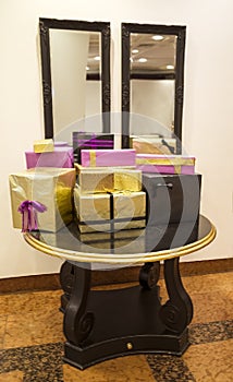 Gift boxes on the table in front of the mirror