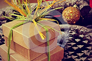 gift boxes tied with natural raffia of different colors on a rustic background