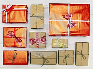 Gift boxes on white wooden background top view. Many gifts and surprises of gifts for Christmas, holiday.