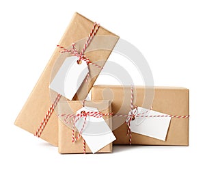 Gift boxes wrapped in kraft paper with tags on white background