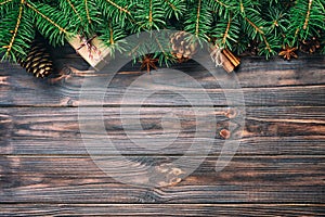 Gift boxwith cinnamon sticks, anise stars, pine cones and pine branches on wooden table. Top view. Christmas gifts in woodan style